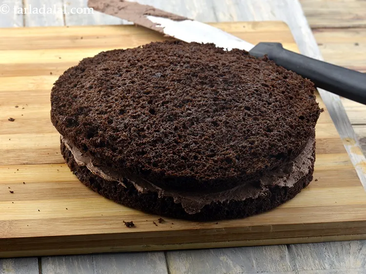 Step 64 – Cover it with another layer of the cake with the soaked layer facing upwards.