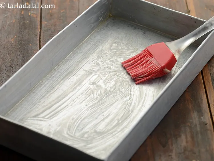 Step 2 – To make&nbsp;<strong>eggless date and almond cake</strong><strong>&nbsp;|&nbsp;healthy Indian date almond cake&nbsp;|&nbsp;khajur badam cake recipe&nbsp;|&nbsp;</strong>grease a baking …