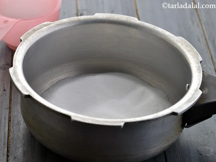 Step 44 – Sprinkle the 1 cup of salt at the base of a pressure cooker.