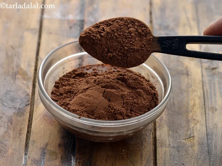 Step 10 – Take a small add 2 tbsp of hot water and add the cocoa powder.