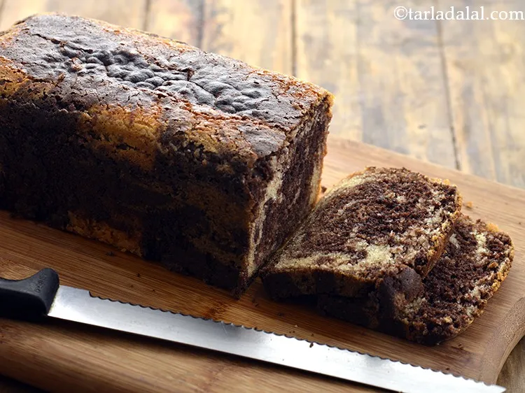 Step 23 – Cut&nbsp;<strong>eggless marble cake</strong>&nbsp;into pieces and serve. You can even top the <strong>marble cake</strong> with frosting …