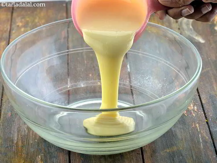 Step 10 – Take another deep and wide mouthed&nbsp;bowl and put the condensed milk into it.