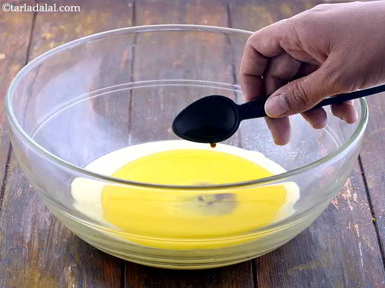 Step 13 – Furthermore, add the vanilla essence into the bowl. Mix all the ingredients well using a …