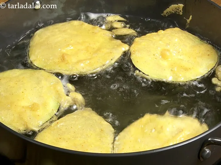 Step 11 – Similarly, dip other 3-4 eggplant slices in batter and drop in oil. Do not overcrowd …