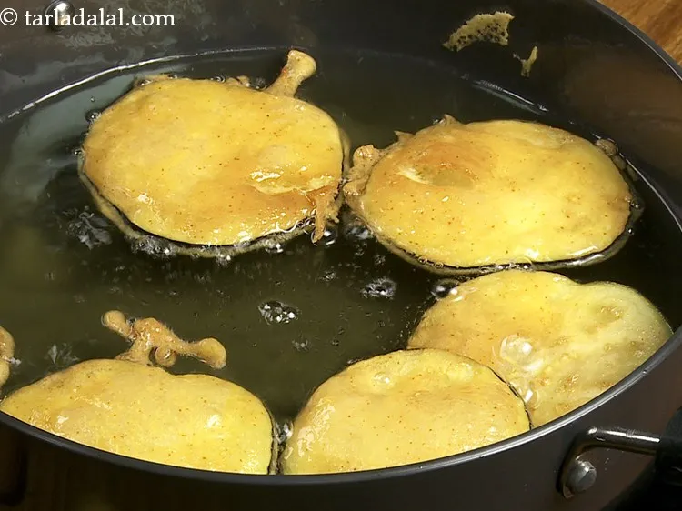 Step 12 – Fry on a medium flame till the bottom of eggplant slices are golden brown.