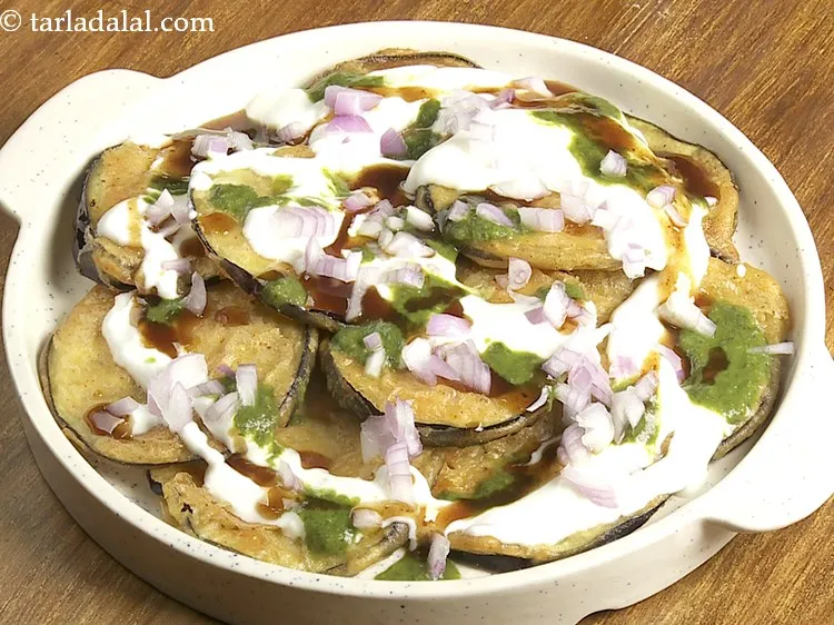 Step 23 – Sprinkle 1 tbsp onions evenly over baigan ki chaat. For an added crunch, you can …