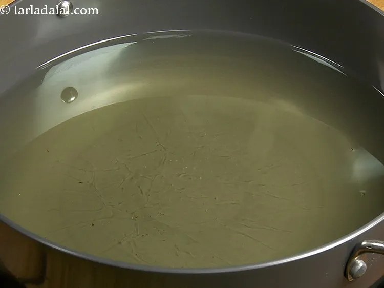 Step 9 – To deep-fry brinjal bhajiya heat the oil in a deep non-stick pan and when hot, …