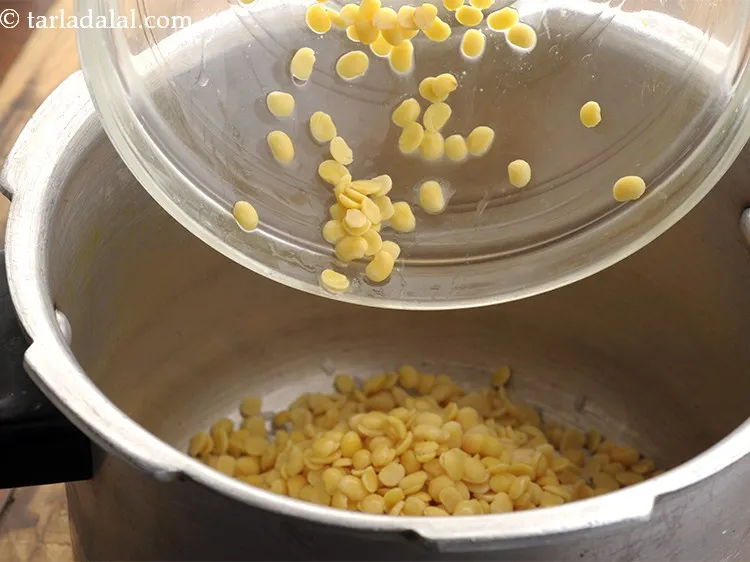 Step 28 – Similarly, drain the toovar dal before adding to the pressure cooker.
