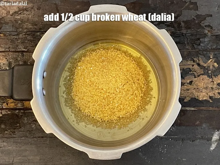 Step 4 – Add&nbsp;<meta charset="UTF-8" />1/2 cup&nbsp;<a href="glossary-broken-wheat-dalia-bulgur-wheat-lapsi-fada-426i">broken wheat (dalia)</a>.