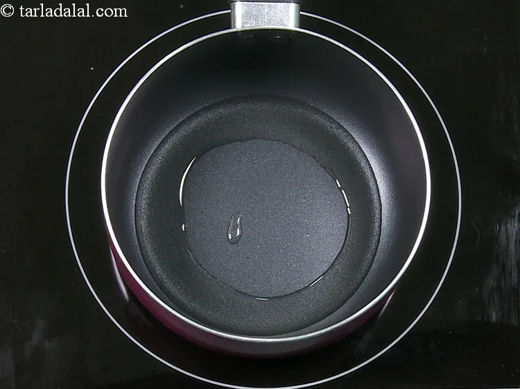 Step 9 – Heat 1 tbsp&nbsp;<a href="https://www.tarladalal.com/glossary-oil-671i">oil</a> in a deep non-stick pan.