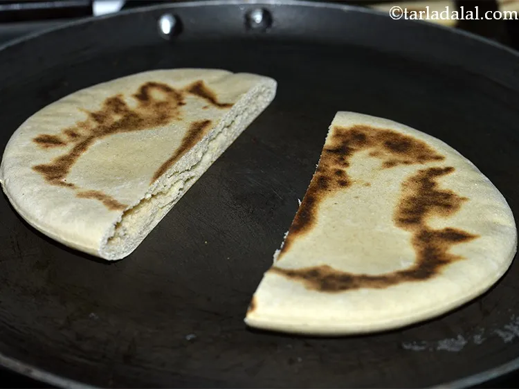 Step 31 – Heat a non-stick tava (griddle) and place the pita pockets over it.&nbsp;Cook it on a …
