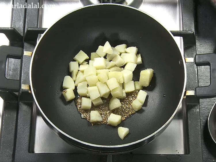 Step 30 – Add 3/4 cup&nbsp;<a href="https://www.tarladalal.com/glossary-boiled-potato-cubes-2312i">boiled potato cubes</a>.