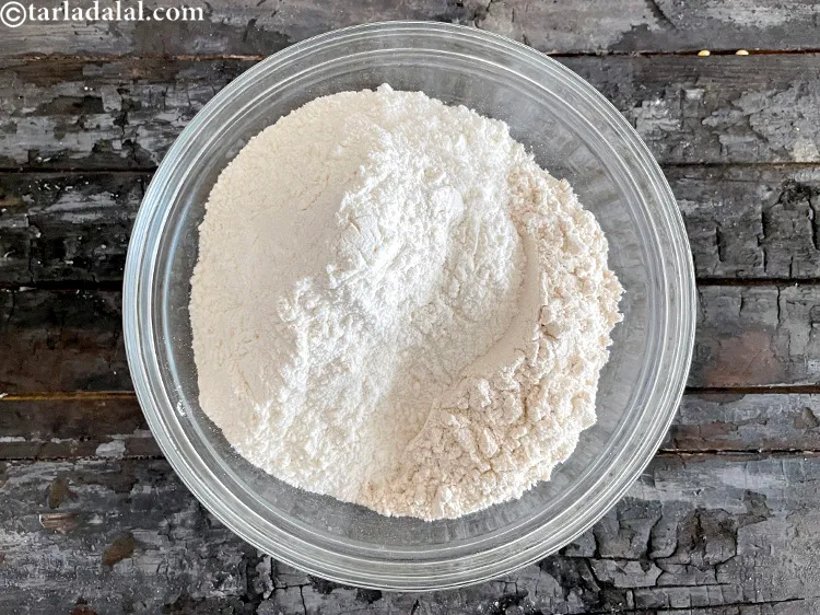 स्टेप 12 – १ १/२ कप <a href=""https://www.tarladalal.com/glossary-plain-flour-maida-hindi-188i"">मैदा</a> डालें।