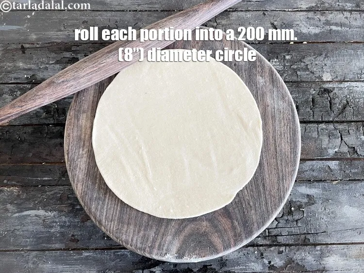 Step 11 – <meta charset="UTF-8" />Roll each portion into a 200 mm. (8&rdquo;) diameter circle.&nbsp;