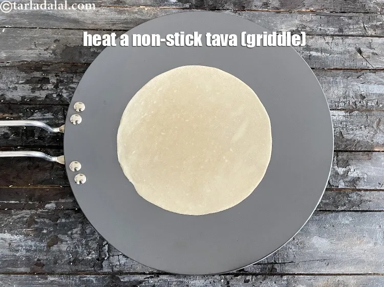 Step 12 – <meta charset="UTF-8" />Heat a non-stick tava (griddle).&nbsp;<br /> &nbsp;