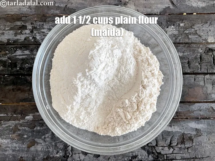 Step 4 – <meta charset="UTF-8" />Add&nbsp;1 1/2 cups&nbsp;<a href="glossary-plain-flour-maida-188i">plain flour (maida)</a>.&nbsp;<br /> &nbsp;