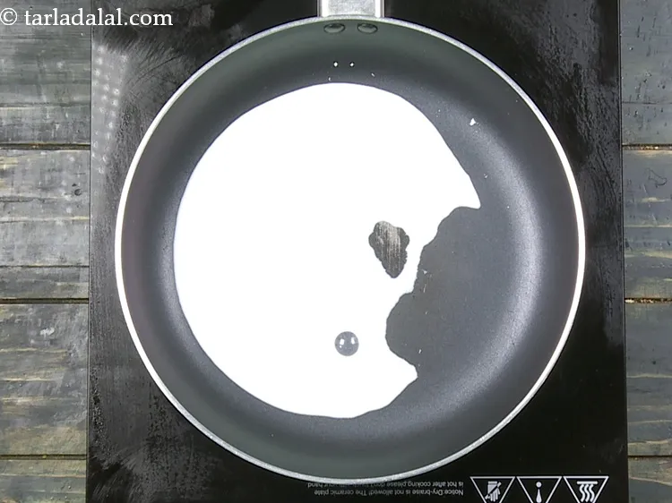 Step 22 – For the <strong>cheese sauce</strong>, add&nbsp;5 tbsp&nbsp;<a href="https://www.tarladalal.com/glossary-milk-doodh-full-cream-milk-514i">milk</a> in a broad non-stick pan.