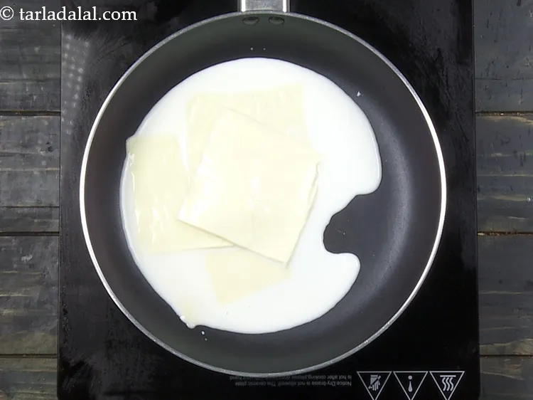 Step 23 – Add 4&nbsp;britannia&nbsp;<a href="https://www.tarladalal.com/glossary-cheese-slices-765i">cheese slices</a>.