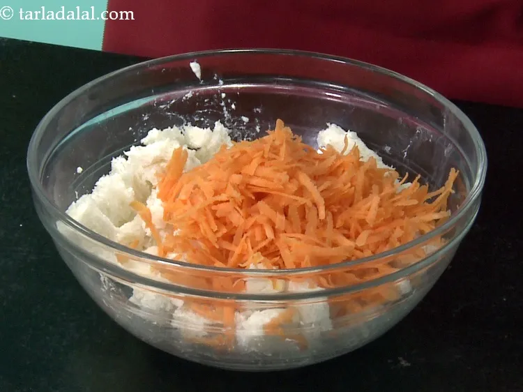 Step 9 – Add 1/2 cup&nbsp;<a href="https://www.tarladalal.com/glossary-grated-carrot-816i">grated carrot</a>.