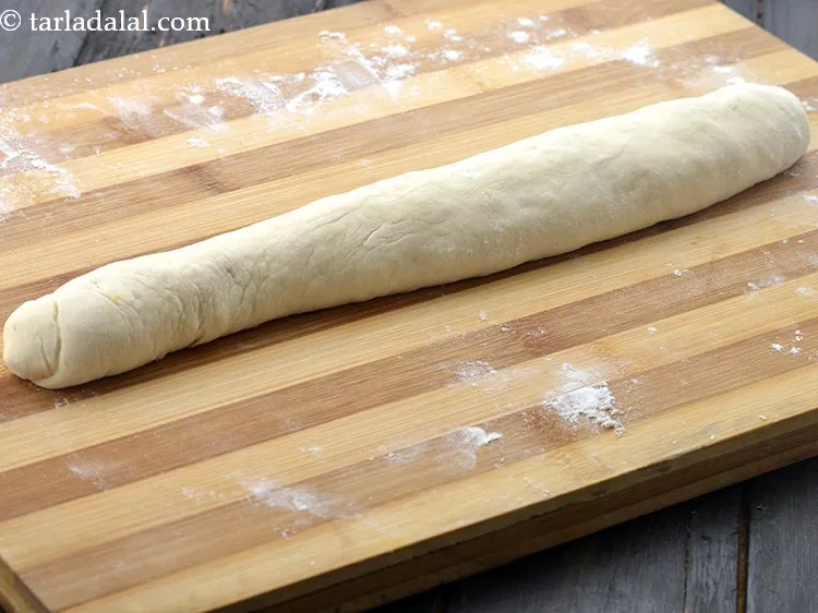 Step 22 – Roll the dough to make a 300 mm. (12&rdquo;) long cylindrical roll and pinch the …