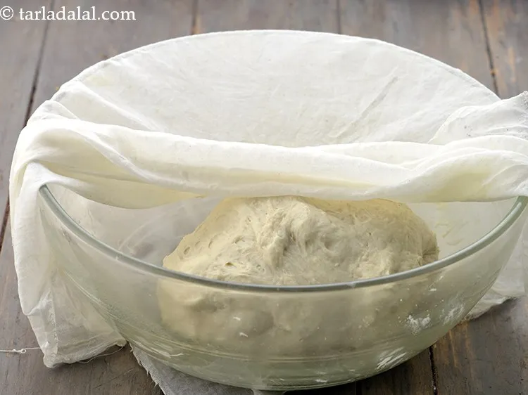 Step 17 – Cover the dough again with a damp muslin cloth and keep aside in a warm …