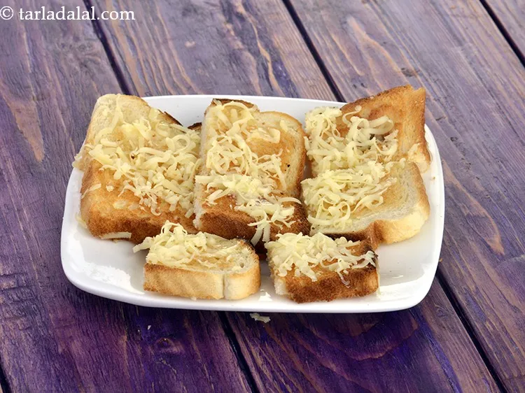 Step 31 – Sprinkle a little <a href="https://www.tarladalal.com/glossary-grated-processed-cheese-868i">grated processed cheese</a>&nbsp;on each piece.