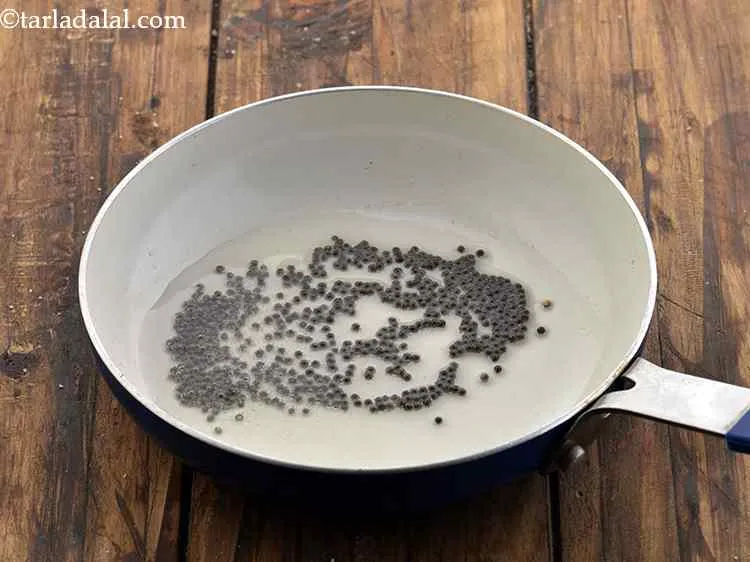 Step 10 – For tempering the fresh <strong>coconut garlic chutney</strong>, heat the oil in a small non-stick pan.&nbsp;Add …