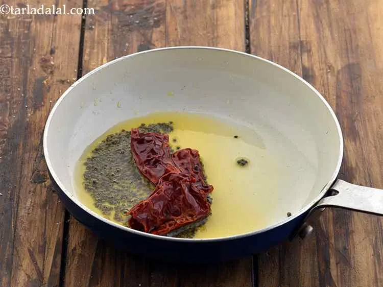 Step 11 – Add the red chillies and saut&eacute; on a medium flame for 1 minute.