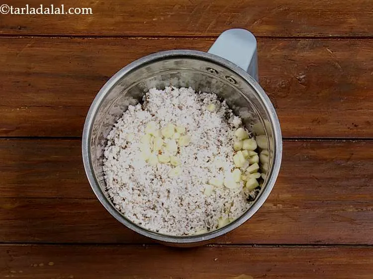 Step 4 – Add the garlic. Peel the garlic cloves and roughly chop it before adding.