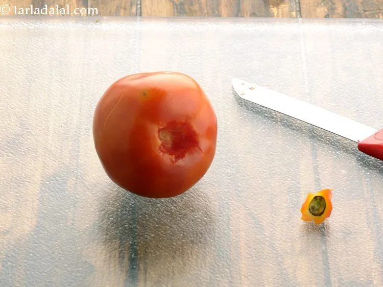 Step 3 – Scoop out and discard the eyes of the tomatoes using the tip of a sharp …