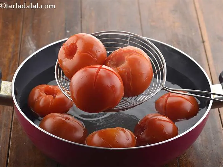 स्टेप 11 – एक खाँचेदार चम्मच का उपयोग करके टमाटर को गर्म पानी …