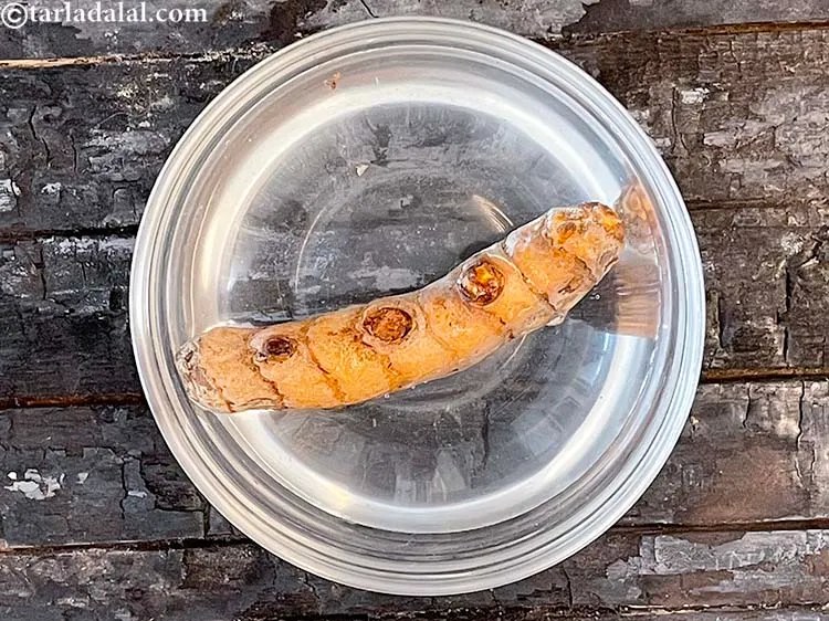 Step 2 – Put the fresh turmeric in a glass bowl and wash the dirt out.