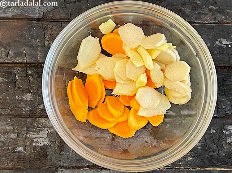 Step 6 – Add 1/4 cup&nbsp;peeled and&nbsp;<a href="https://www.tarladalal.com/glossary-sliced-tender-ginger-2780i">sliced tender ginger (adrak)</a>.