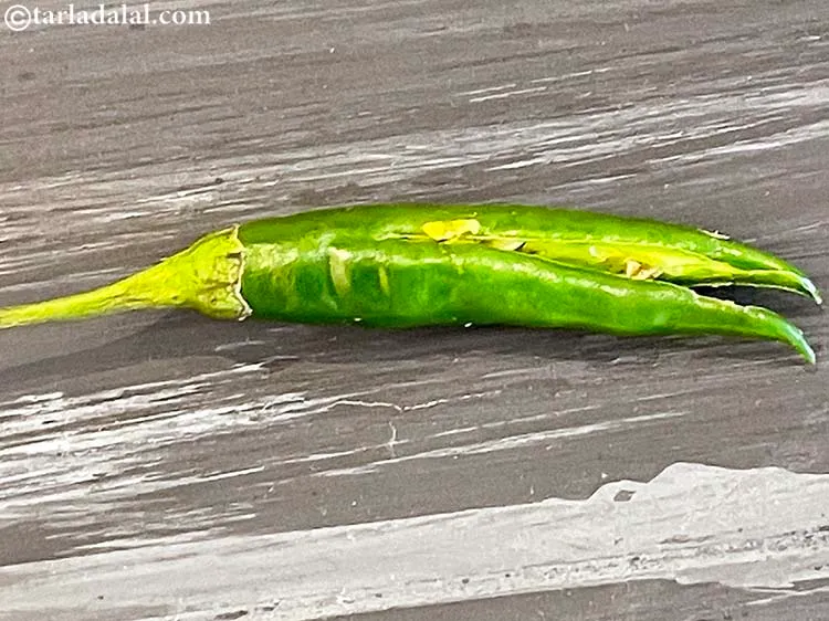 Step 3 – Slit the chillies through the centre by using a sharp knife. This prevents the chillies …