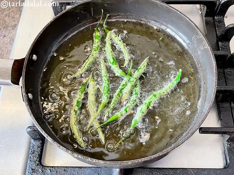Step 5 – Deep-fry the chillies till they turn whitish in colour.&nbsp;