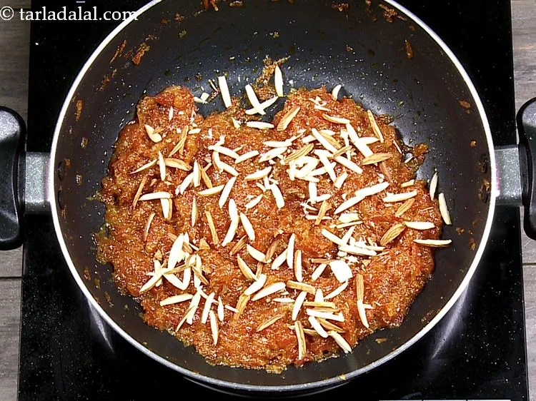 Step 22 – Garnish <strong>gajar halwa</strong> with almond slivers. Other dried fruits like raisins, cashew nuts, pistachios can …