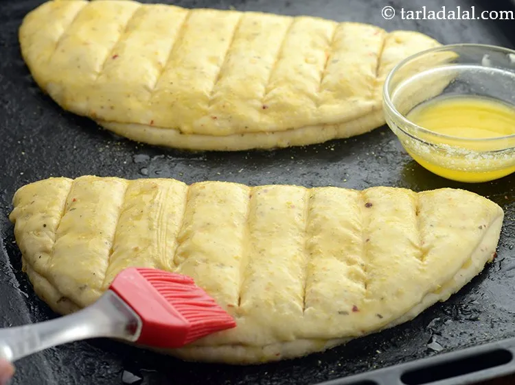Step 38 – Brush 2 tsp of melted butter over each garlic bread.