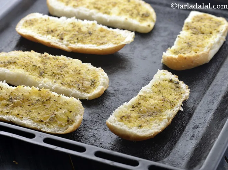 Step 12 – Arrange the prepared <strong>garlic breads</strong> on a baking tray. You can also sprinkle <strong>garlic bread</strong> …