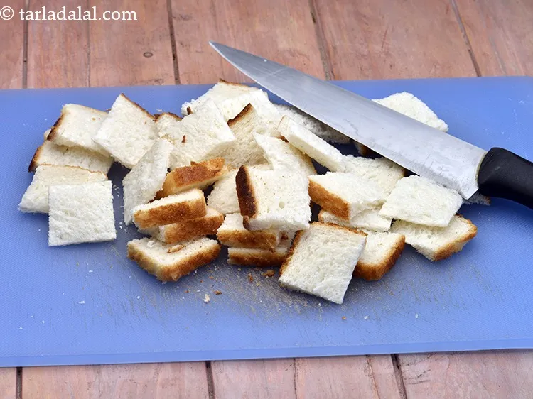 Step 4 – Cut the bread slices into 4 to 6 cubes. Do not trim the edges.&nbsp;