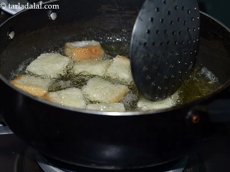 Step 6 – Add a few bread pieces in it and deep-fry till they turn golden brown in …