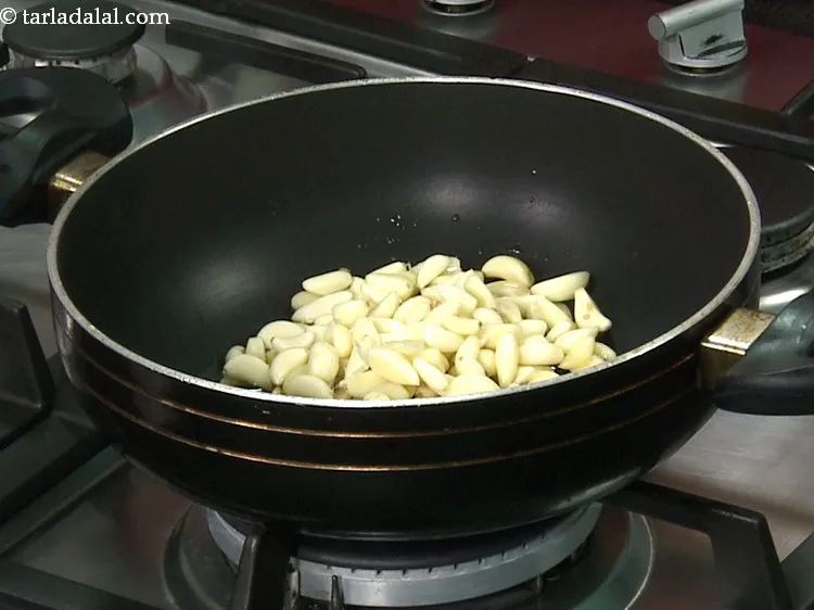 Step 8 – Once the oil is hot, add the garlic cloves. Ensure there is no larvae, mold …