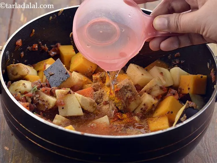 Step 24 – Mix well and add 1&frac12;&nbsp; cup of water to cook the vegetables.