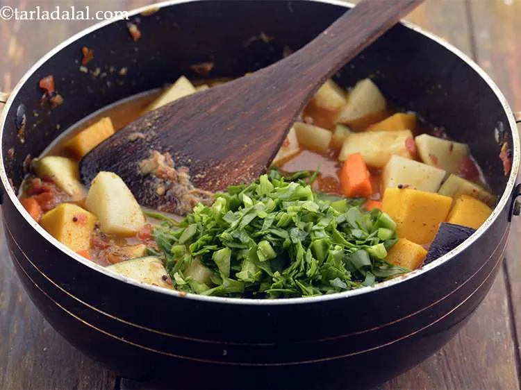 Step 25 – Add the Poi saag. Cover with a lid. This will cook the vegetables faster.