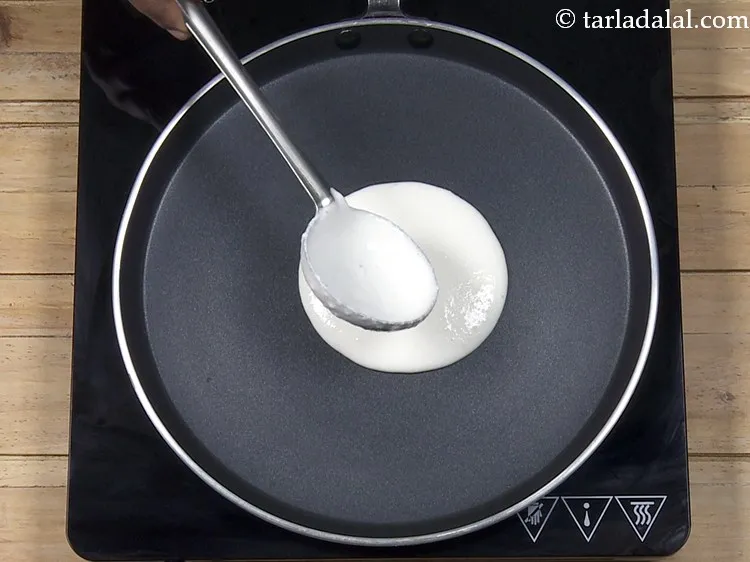 Step 26 – Pour a ladleful of the batter on the tava.