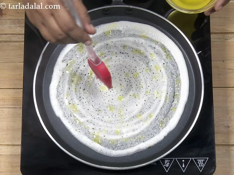 Step 28 – Drizzle 1 tsp of ghee evenly over <strong>dosa ghee roast</strong>.