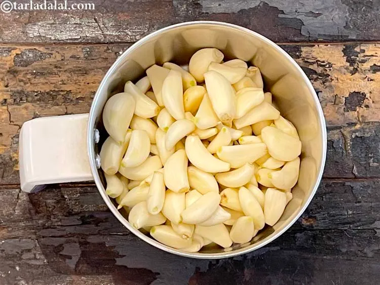 Step 2 – In a mixer, put&nbsp;<meta charset="UTF-8" />1 cup&nbsp;peeled&nbsp;<a href="glossary-garlic-lehsun-lahsun-348i">garlic (lehsun)</a>.&nbsp;You can buy readymade garlic or peel …