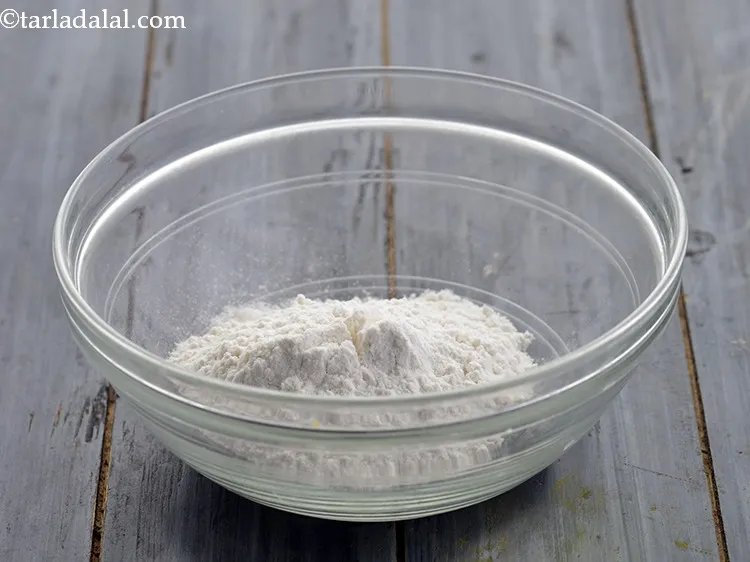 Step 12 – For preparing the batter to coat the cauliflower florets, in a deep bowl, take plain …