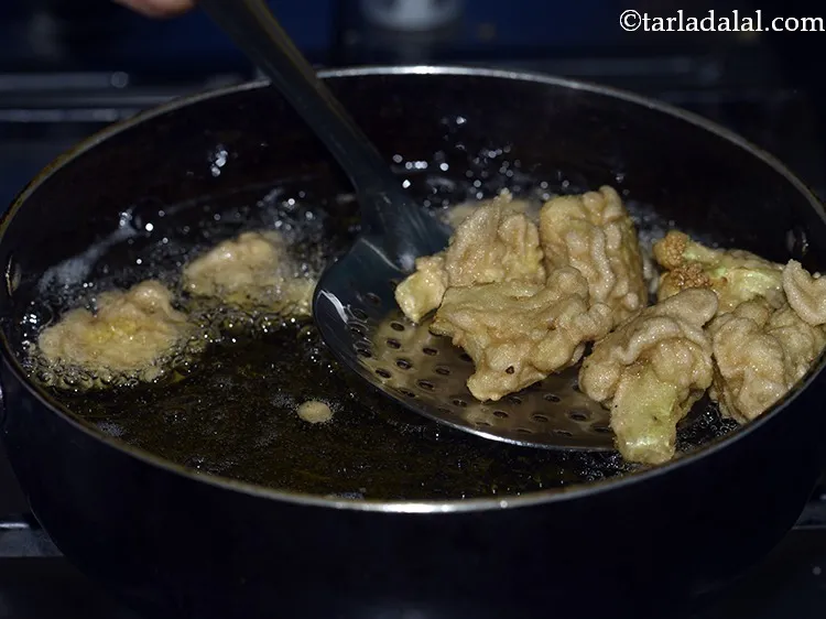 Step 22 – Deep-fry on a medium flame till they turn golden brown in colour from all the …