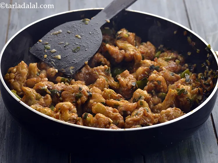 Step 42 – Toss well and cook on a high flame for 2 minutes, while stirring occasionally. Tossing …