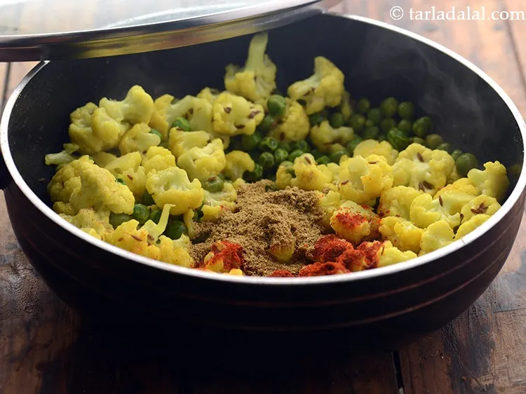 Step 12 – Add coriander-cumin seeds powder. To enhance the flavor of matar gobi, you can add garam …